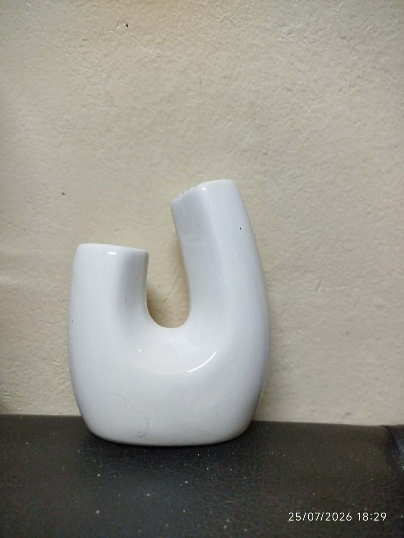 White Ceramic U-Shaped Vase (Category: Vases & Decorative Bowls) located in Quezon City. Submitted by chadrison (Listing ID 1451826075, Image 2). Description: - Unique white ceramic vase - Modern U-shape design - Ideal for small bouquets or single stems - Adds a minimalist touch to any space - Great for dried flowers or standalone decor.