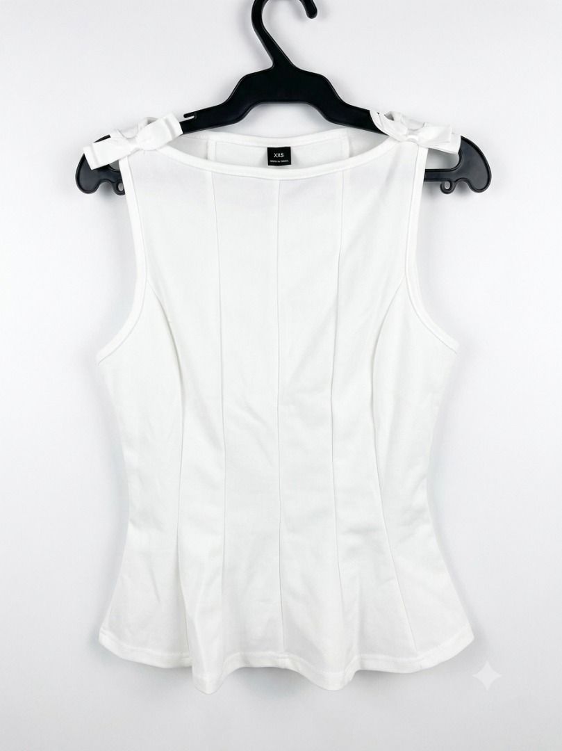 White Sleeveless Top with Bows XSS (Category: Luxury Apparel) located in Davao. Submitted by pickystuff (Listing ID 1451855489, Image 1). Description: - White sleeveless top - Bow details on shoulders - Fitted silhouette - Scoop neckline - Slightly flared hem xxs on tag but fits xs to s.