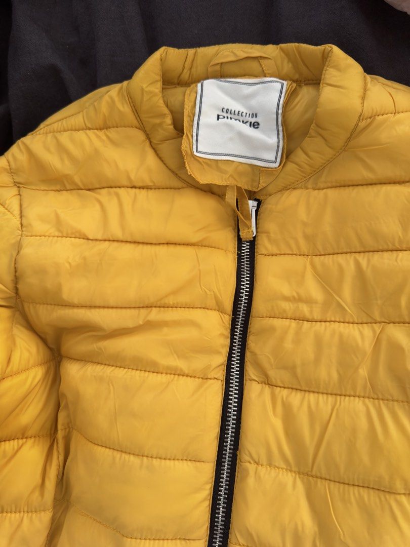 Yellow Puffer Jacket (Category: Coats, Jackets and Outerwear) located in Makati City. Submitted by tinkerboy (Listing ID 1451708756, Image 2). Description: - Bright yellow puffer jacket - Full zip-up front closure - Two convenient zip pockets - Lightweight yet warm for comfort - Perfect for chilly days and easy to style.