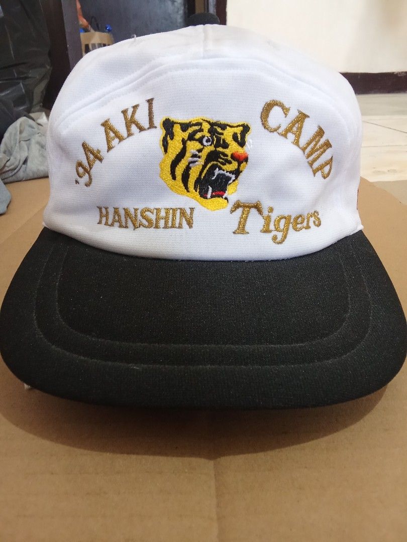 1994 Hanshin Tigers Aki Camp Baseball Cap (Category: Caps & Hats) located in Davao. Submitted by kristian2020 (Listing ID 1451905517, Image 1). Description: - Vintage 1994 Hanshin Tigers cap - Color: White with black brim - Features embroidered tiger logo - 'PRESS' embroidered on the side - Adjustable strap at the back - Ideal for collectors and fans - cap from japan surplus, expect dust dirt at top.
