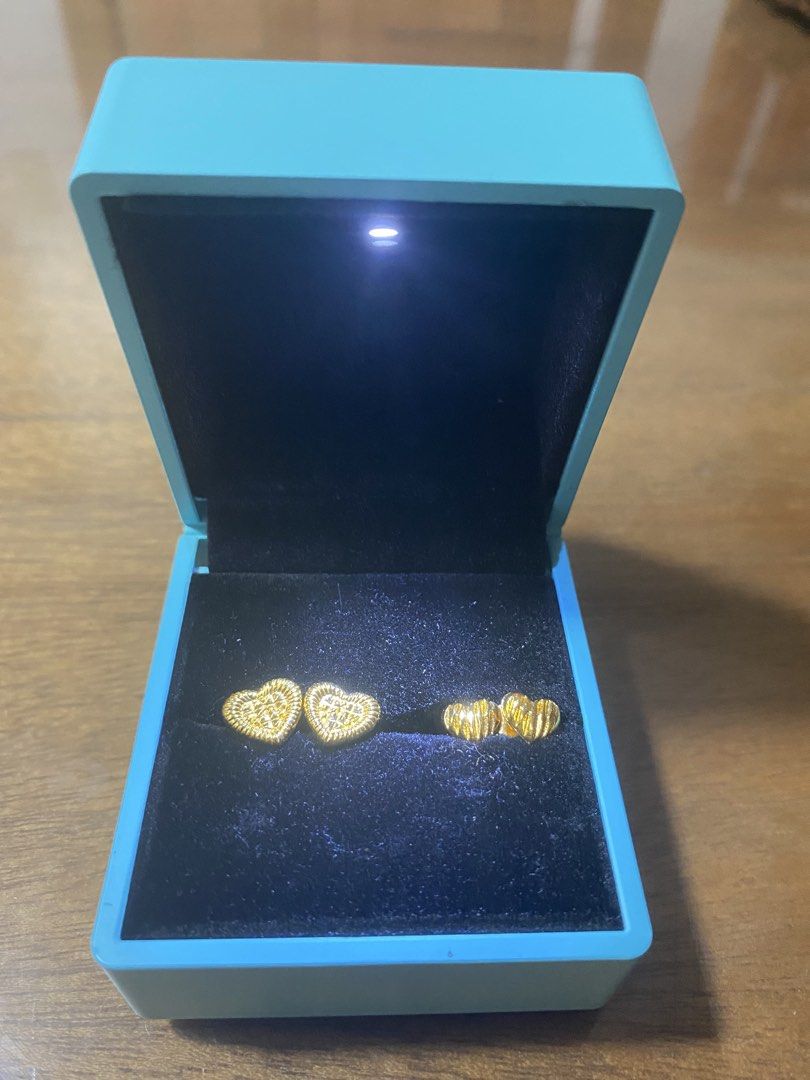 2 Gold Tone Heart Earrings (Category: Earrings) located in San Pedro. Submitted by chinitagrace21 (Listing ID 1452030490, Image 1). Description: - Cute gold heart earrings and matching ring set. - Comes in a beautiful teal jewelry box. - Built-in light in the jewelry box. - Looks shiny and brand new. - Perfect for gifting or personal treat..