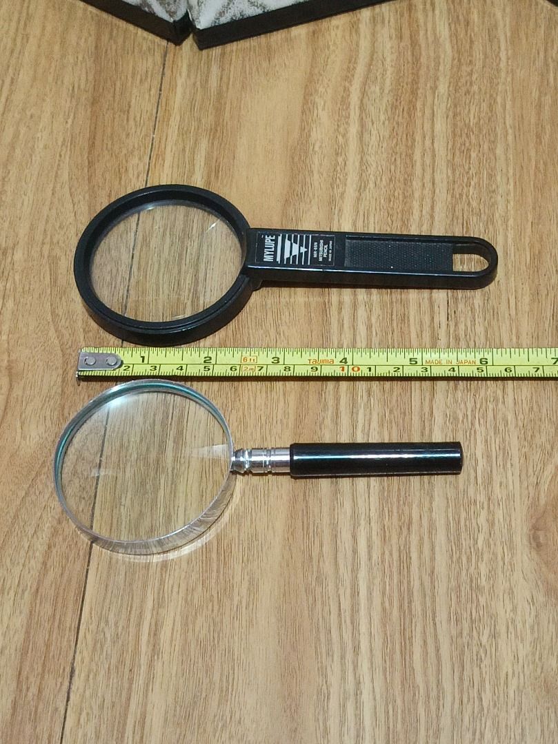 2 Magnifying Glasses - Mylupe and Classic Style (Category: Sunglasses & Eyewear) located in Makati City. Submitted by nyxhemera26 (Listing ID 1452036858, Image 2). Description: 2 Magnifying Glasses - Mylupe and Classic Style - Mylupe MR-85N model with text on handle. - Classic style magnifier with black handle and metal ferrule. - Ideal for reading small print, hobbies, and general use..