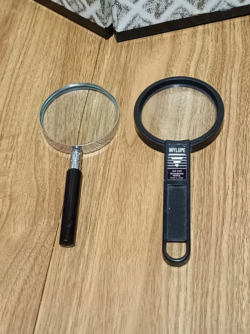2 Magnifying Glasses - Mylupe and Classic Style (Category: Sunglasses & Eyewear) located in Makati City. Submitted by nyxhemera26 (Listing ID 1452036858, Image 1). Description: 2 Magnifying Glasses - Mylupe and Classic Style - Mylupe MR-85N model with text on handle. - Classic style magnifier with black handle and metal ferrule. - Ideal for reading small print, hobbies, and general use..