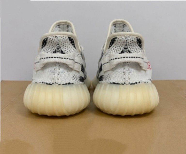 Adidas Yeezy Boost 350 V2 Zebra (Category: Sneakers) located in Batangas. Submitted by curatedluxxe88 (Listing ID 1452099084, Image 3). Description: - Iconic Adidas Yeezy Boost 350 V2 Zebra design - Classic black and white zebra stripe pattern - Bold red 'SPLY-350' text on the side - Comfortable knit upper for a snug fit - Responsive Boost sole for all-day comfort - Ideal for everyday wear and streetwear style.