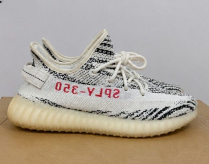 Adidas Yeezy Boost 350 V2 Zebra (Category: Sneakers) located in Batangas. Submitted by curatedluxxe88 (Listing ID 1452099084, Image 2). Description: - Iconic Adidas Yeezy Boost 350 V2 Zebra design - Classic black and white zebra stripe pattern - Bold red 'SPLY-350' text on the side - Comfortable knit upper for a snug fit - Responsive Boost sole for all-day comfort - Ideal for everyday wear and streetwear style.