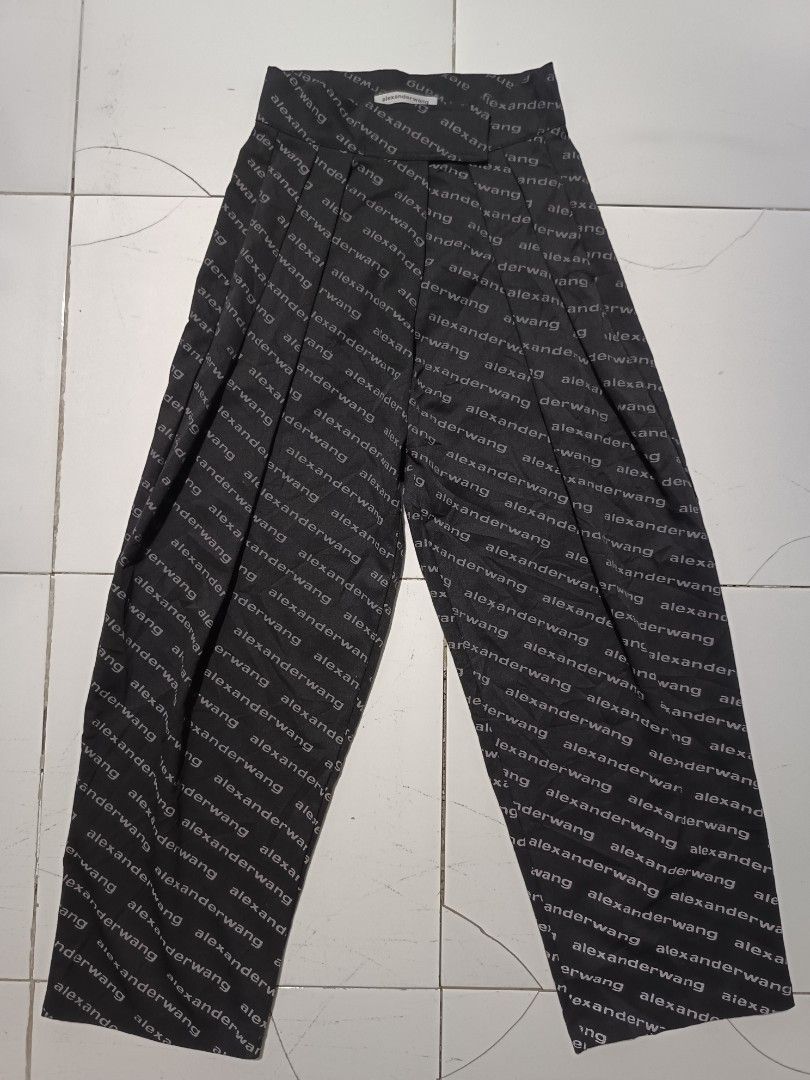 Alexander Wang All Over Logo Pants (Category: Other Bottoms) located in Barotac Nuevo. Submitted by gray101 (Listing ID 1452051485, Image 1). Description: - Alexander Wang pants with all-over logo print - Color: Black with grey text - Material: 100% Cotton body, 100% Polyester trim - Origin: Made in Turkey - Unique features: Pleated front, velcro closure - A bold statement piece for your wardrobe - Reflector script .