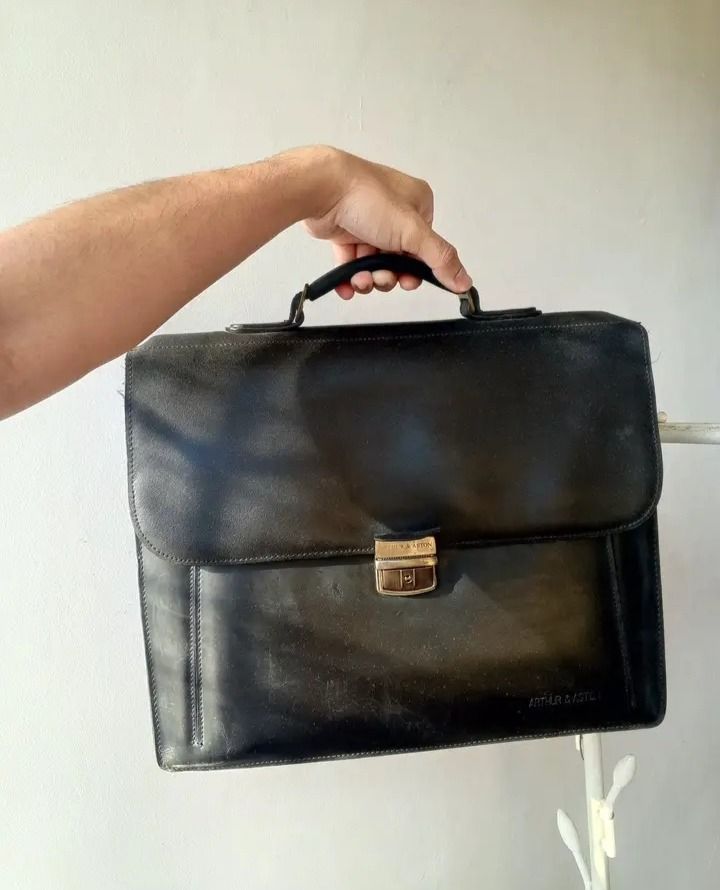 Arthur & Aston Black Leather Briefcase (Category: Briefcases) located in Caloocan City. Submitted by paulhernal88183 (Listing ID 1451980265, Image 1). Description: - Classic black leather briefcase by Arthur & Aston. - Features a secure clasp closure. - Comfortable top handle for easy carrying. - Ample interior space for documents and a laptop. - Ideal for work, office, or business trips..