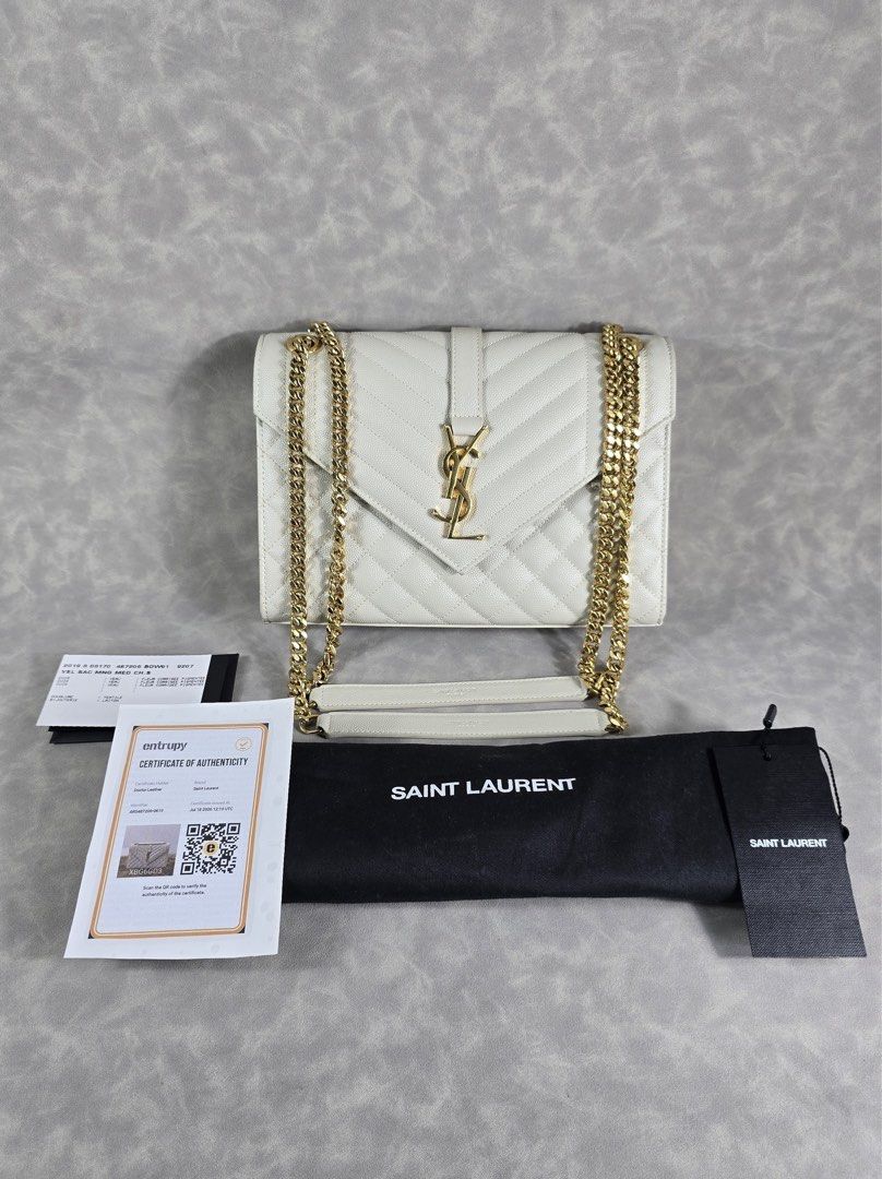 Authentic YSL Envelope Medium Cream GHW (Category: Luxury Bags & Wallets) located in Taguig. Submitted by luxchelry (Listing ID 1452070598, Image 1). Description: Envelope Medium GHW ♦️Comes with dustbag, entrupy and carecards ♦️9.8/10 ♦️Any discoloration is due to lighting only. ✨️P88000✨️ 📍Taguig All items are 100% authentic. Money back guarantee if the item is proven fake. Disclaimer: All product names, logos, brands and other trademarks or i