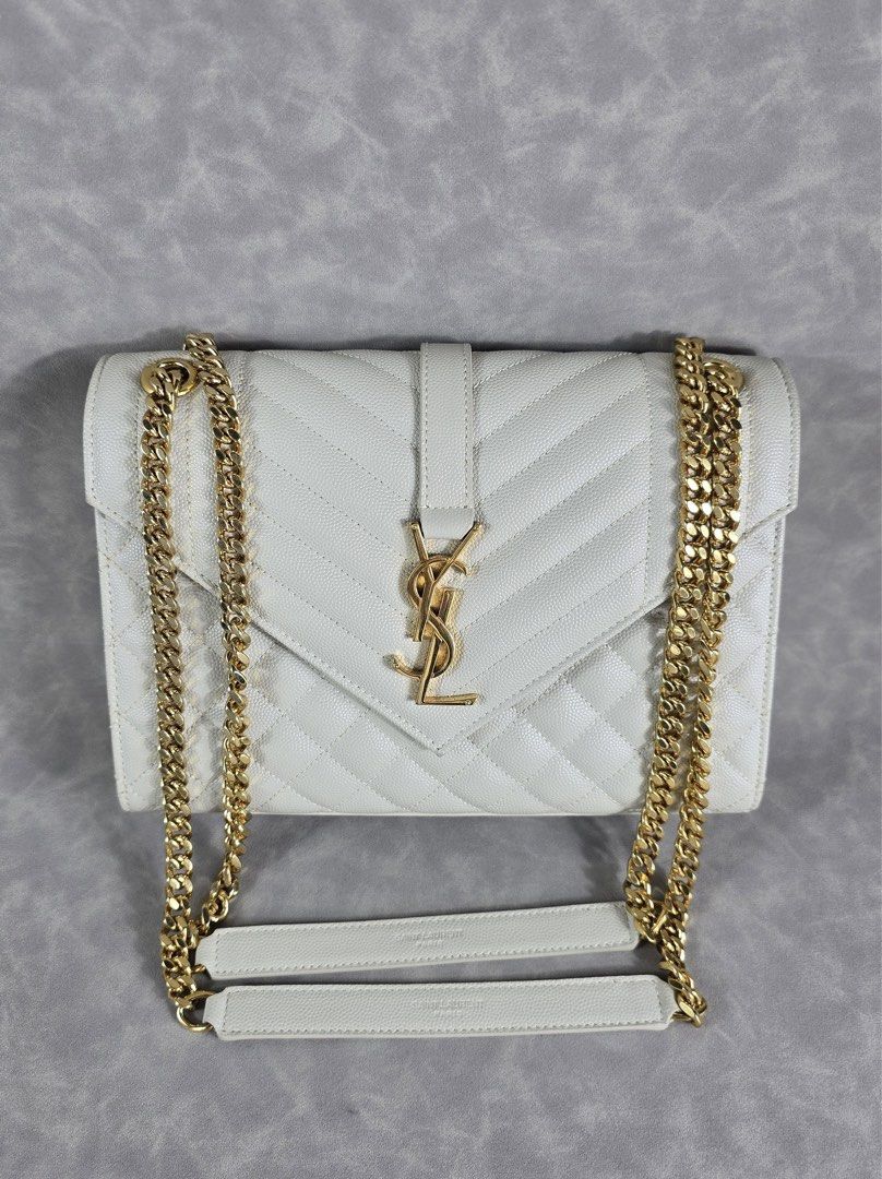 Authentic YSL Envelope Medium Cream GHW (Category: Luxury Bags & Wallets) located in Taguig. Submitted by luxchelry (Listing ID 1452070598, Image 2). Description: Envelope Medium GHW ♦️Comes with dustbag, entrupy and carecards ♦️9.8/10 ♦️Any discoloration is due to lighting only. ✨️P88000✨️ 📍Taguig All items are 100% authentic. Money back guarantee if the item is proven fake. Disclaimer: All product names, logos, brands and other trademarks or i
