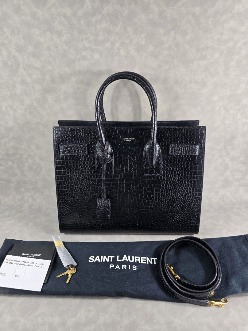 Authentic YSL Sac de Jour Mini Croc (Category: Luxury Bags & Wallets) located in Taguig. Submitted by luxchelry (Listing ID 1452069668, Image 1). Description: Sac de Jour Mini Croc ♦️Comes with dustbag, strap, carecards, lock and keys ♦️9.5/10 ♦️Any discoloration is due to lighting only. ✨️P57000✨️ 📍Taguig All items are 100% authentic. Money back guarantee if the item is proven fake. Disclaimer: All product names, logos, brands and other tradema