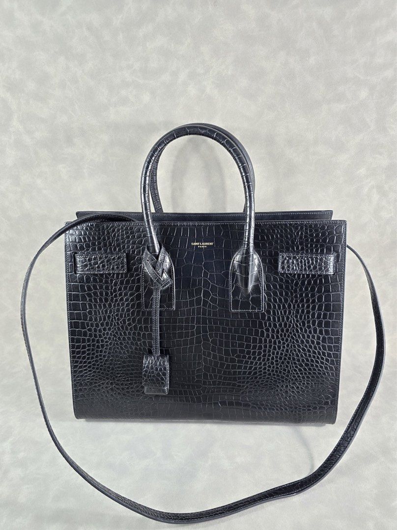 Authentic YSL Sac de Jour Mini Croc (Category: Luxury Bags & Wallets) located in Taguig. Submitted by luxchelry (Listing ID 1452069668, Image 2). Description: Sac de Jour Mini Croc ♦️Comes with dustbag, strap, carecards, lock and keys ♦️9.5/10 ♦️Any discoloration is due to lighting only. ✨️P57000✨️ 📍Taguig All items are 100% authentic. Money back guarantee if the item is proven fake. Disclaimer: All product names, logos, brands and other tradema