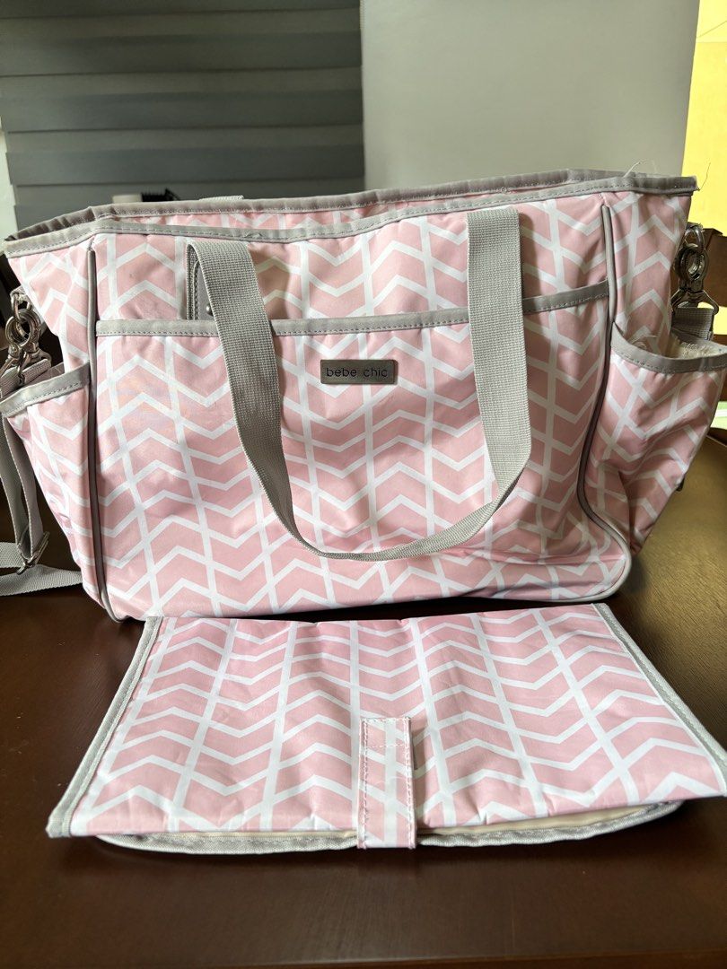 Bebe Chic Pink Diaper Bag (Category: Diaper Bags & Wetbags) located in Mandaluyong City. Submitted by k_and_k_preloved_corner (Listing ID 1451969446, Image 1). Description: - Bebe Chic Diaper Bag from Rustans - Color Pink - Very clean but with tear in one pocket - Spacious with many pockets for baby bottles - Comes with a changing pad.