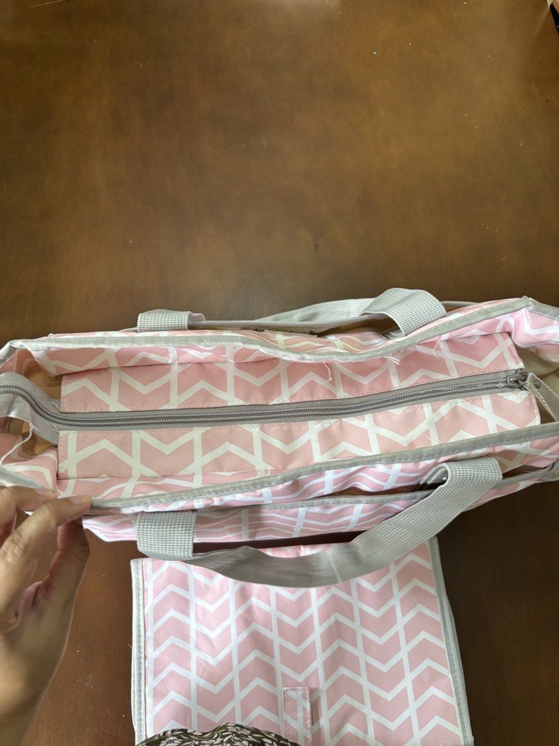 Bebe Chic Pink Diaper Bag (Category: Diaper Bags & Wetbags) located in Mandaluyong City. Submitted by k_and_k_preloved_corner (Listing ID 1451969446, Image 3). Description: - Bebe Chic Diaper Bag from Rustans - Color Pink - Very clean but with tear in one pocket - Spacious with many pockets for baby bottles - Comes with a changing pad.