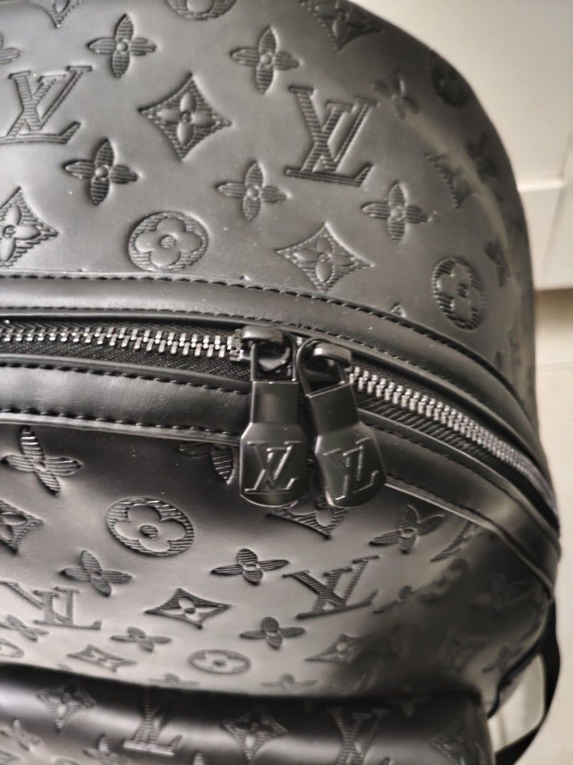 Black Backpack (Category: Bags & Wallets) located in Singapore. Submitted by ammaarriza49229 (Listing ID 1452067992, Image 2). Description: Black leather backpack. Features the iconic monogram pattern embossed all over. Has a front zip pocket and a spacious main compartment with internal pockets. Zippers have logos. Great for everyday use or travel..