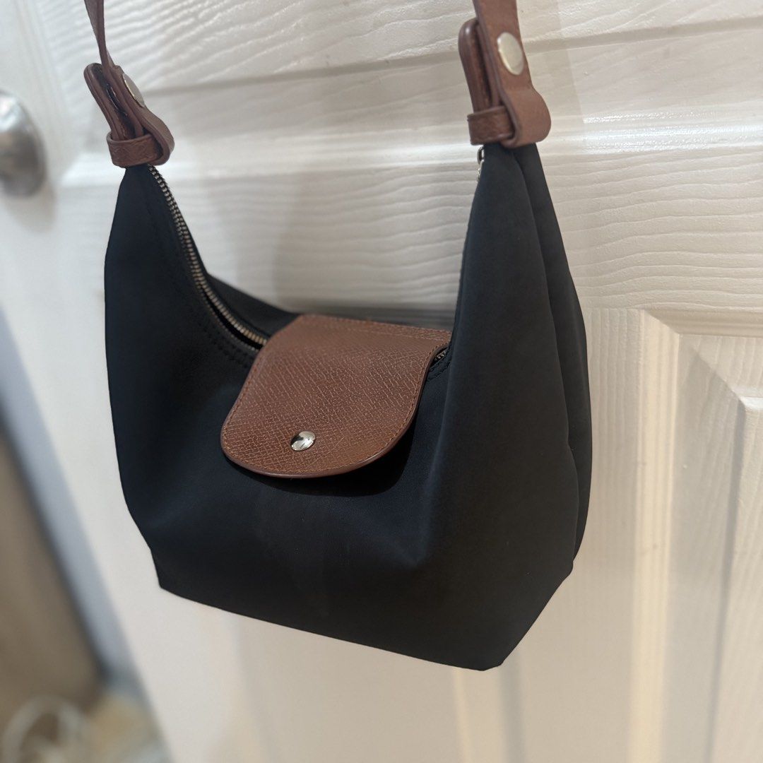 Black Nylon Shoulder Bag with Brown Leather Trim (Category: Shoulder Bags) located in Quezon City. Submitted by _seyer (Listing ID 1451971247, Image 3). Description: - Cute black nylon shoulder bag - Brown leather accents on flap and strap - Zipper closure - Black lining inside - Great for everyday use - Compact and easy to carry.