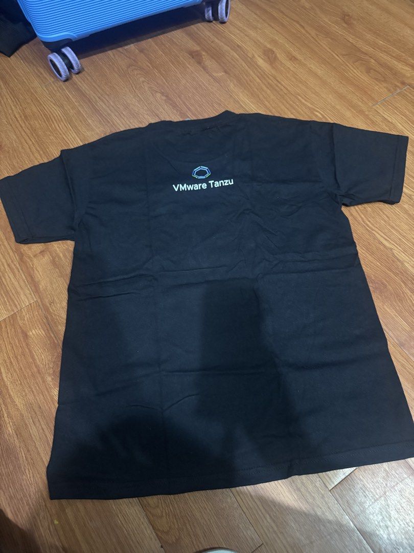 Black VMware Tanzu Java Spring T-shirt (Category: Tshirts & Polo Shirts ) located in Las Pinas. Submitted by katfg (Listing ID 1451961258, Image 2). Description: - Black t-shirt - Features 'Spring' logo on the front - 'VMware Tanzu' text on the back - Made from comfortable cotton material - Ideal for tech events or casual wear - Logos are clearly visible.
