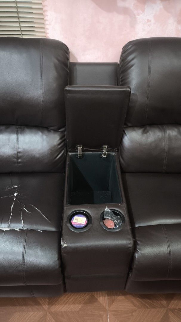 Brown Leather Recliner Sofa with Cup Holders (Category: Sofas) located in Paranaque City. Submitted by Colleen.agsalud (Listing ID 1451915931, Image 2). Description: - Dark brown two-seater recliner sofa - Central console with cup holders and storage - Both seats fully recline for ultimate comfort - Ideal for home theater or everyday relaxation.