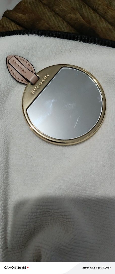 Bulgari Serpenti mirror Round Mirror with Leather Accent (Category: Mirrors) located in Manila. Submitted by lavu4555 (Listing ID 1451970678, Image 1). Description: - Authentic Bvlgari round mirror - Elegant gold tone metal frame - Chic light pink leather accent detail - Compact and portable for easy carrying - Ideal for quick touch-ups anywhere - One side features protective backing - Clean and minimalist design.