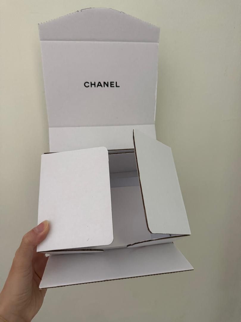 Chanel White Cardboard Packaging Box (Category: Storage Boxes & Baskets) located in Kuala Lumpur. Submitted by beauart59816 (Listing ID 1451979916, Image 1). Description: - Original Chanel packaging box - White cardboard material - Features clear Chanel logo - Folds open for convenient storage or display - Ideal for protecting Chanel items or for gifting.