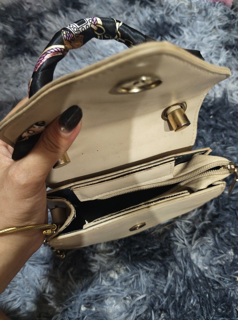Charles & Keith Beige Croc Embossed Triangle Handbag with Scarf (Category: Luxury Bags & Wallets) located in Manila. Submitted by querobin11 (Listing ID 1452029337, Image 3). Description: - Stylish beige triangle handbag - Elegant croc-embossed flap - Adorable scarf tied to the handle - Includes a chic gold chain strap - Compact size, ideal for carrying essentials - Interior and exterior are clean RFS DECLUTTERING .