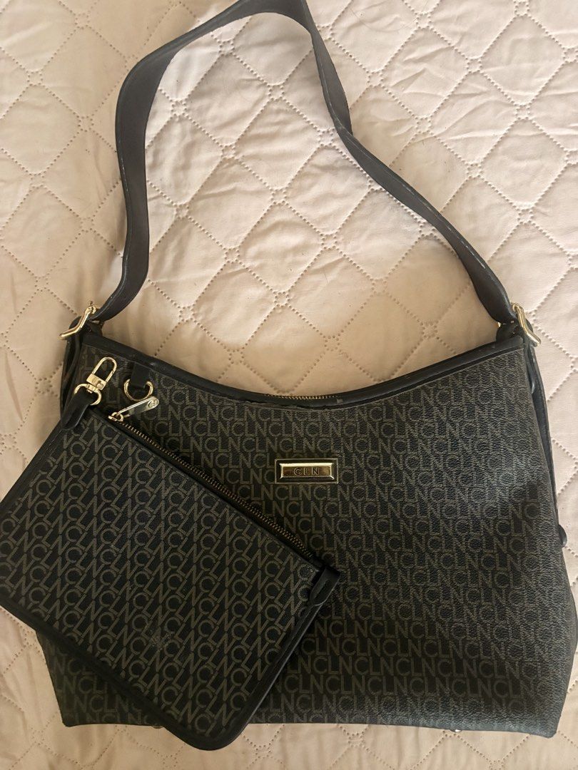 CLN Ariellah Shoulder Bag in black (Category: Shoulder Bags) located in Legazpi City. Submitted by satowa00 (Listing ID 1451965162, Image 1). Description: CLN Ariellah Shoulder Bag in black Original Price: P2499‼️ Selling Price: P1000 only (super steal) Condition: 9/10 - It is crafted from PU leather and features a zip-top closure. - The interior includes a central compartment, a zip pocket, and a slip pocket. - Just needs cleaning but flaws are 