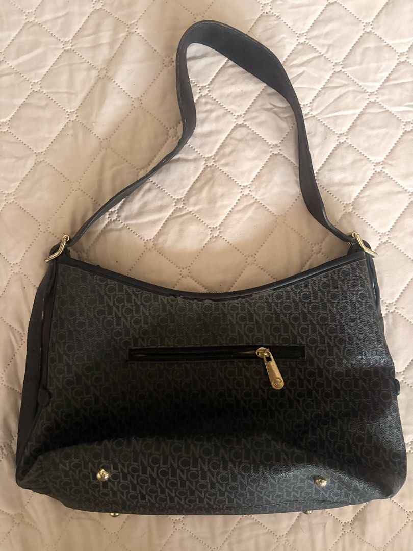 CLN Ariellah Shoulder Bag in black (Category: Shoulder Bags) located in Legazpi City. Submitted by satowa00 (Listing ID 1451965162, Image 3). Description: CLN Ariellah Shoulder Bag in black Original Price: P2499‼️ Selling Price: P1000 only (super steal) Condition: 9/10 - It is crafted from PU leather and features a zip-top closure. - The interior includes a central compartment, a zip pocket, and a slip pocket. - Just needs cleaning but flaws are 