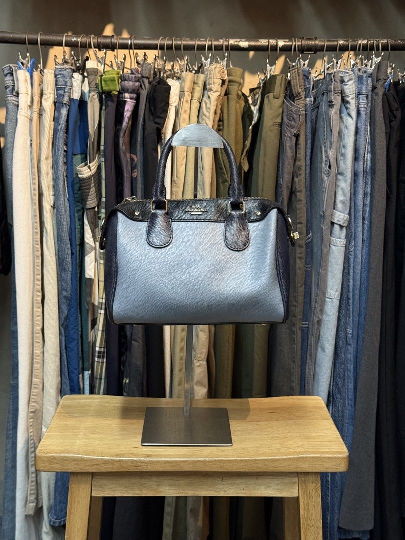 Coach Pebbled Leather Satchel Bag Navy Blue Grey (Category: Luxury Bags & Wallets) located in Legazpi City. Submitted by deadthrift (Listing ID 1452096150, Image 1). Description: - Coach satchel bag - Mix of grey and navy blue pebbled leather - Gold hardware details - Zipper closure - Top handles - Interior Coach creed patch - Great everyday bag.