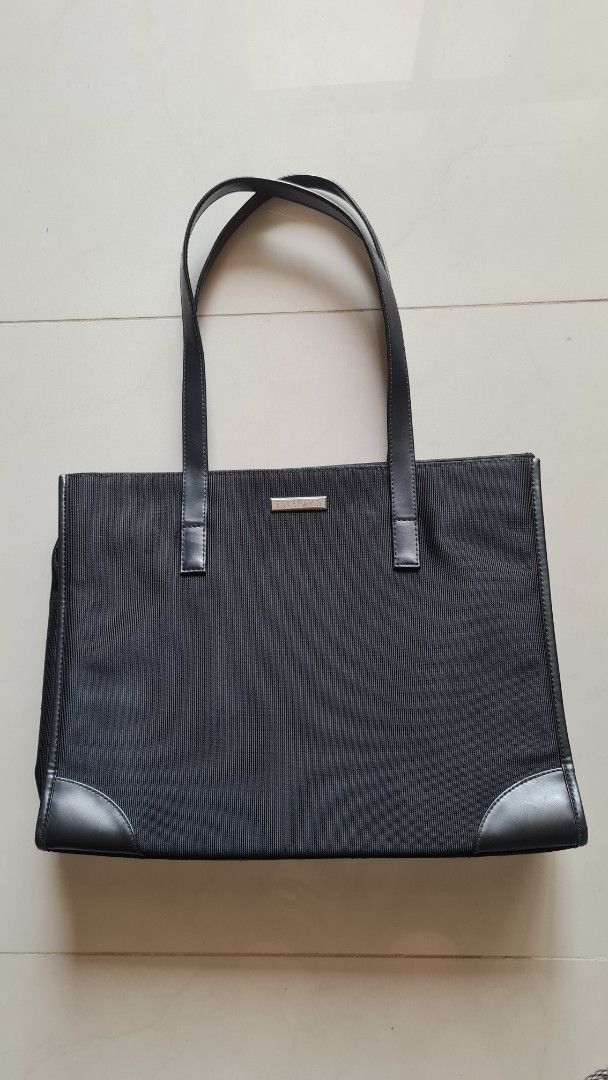 Elle Paris Black Tote Bag with Leather Strap (Category: Tote Bags) located in Kuala Lumpur. Submitted by cm_to (Listing ID 1451968690, Image 1). Description: - Preparing to immigrate need emptying house of belongings. Pls to go my profile for more luxury and valued items to sell. - Size : 15'x 11' - Classic black tote bag - Textured fabric with smooth leather trim - Two comfortable shoulder straps - Small metal plate detail on the front - Ideal f