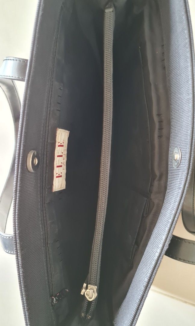 Elle Paris Black Tote Bag with Leather Strap (Category: Tote Bags) located in Kuala Lumpur. Submitted by cm_to (Listing ID 1451968690, Image 3). Description: - Preparing to immigrate need emptying house of belongings. Pls to go my profile for more luxury and valued items to sell. - Size : 15'x 11' - Classic black tote bag - Textured fabric with smooth leather trim - Two comfortable shoulder straps - Small metal plate detail on the front - Ideal f