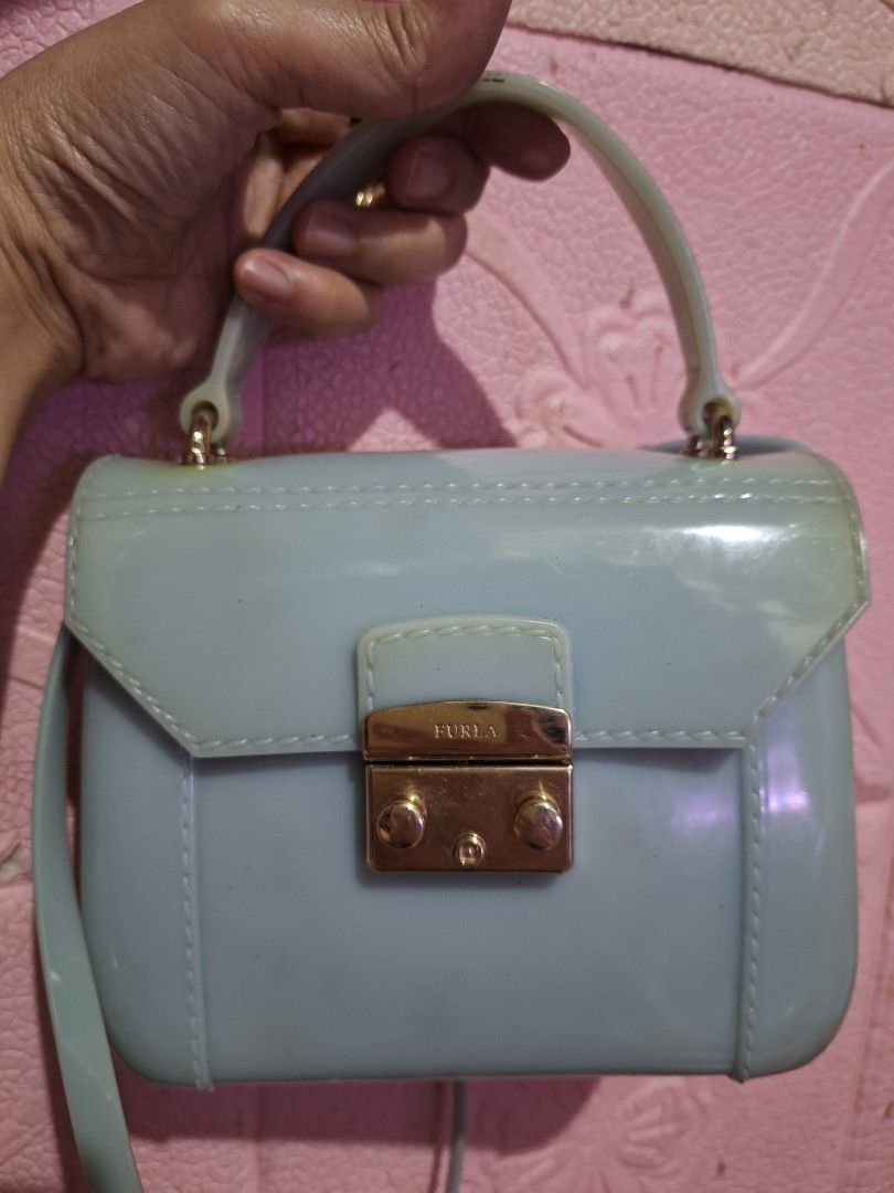 Furla Candy Bon Bon Mini Bag Pale Blue (Category: Luxury Bags & Wallets) located in Quezon City. Submitted by cloudymay (Listing ID 1451901122, Image 2). Description: - Adorable pale blue Furla Candy Bon Bon mini bag - Unique shiny jelly-like material - Features a chic top handle - Includes a detachable shoulder strap for versatility - Elegant gold-toned clasp with embossed Furla logo - Adds a vibrant pop of color to any outfit .