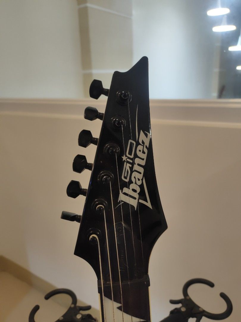 Ibanez GIO Electric Guitar (Category: Musical Instruments) located in Manila. Submitted by shop.zane (Listing ID 1451923658, Image 2). Description: Ibanez GIO Electric Guitar (Black Burst) + Padded Gig Bag Selling Ibanez GIO electric guitar in very good condition. Perfect for beginners, intermediate players, or anyone looking for a reliable guitar for practice, gigs, or recording. Features: HSH pickup configuration (Humbucker-Single-Humbucker) Tr