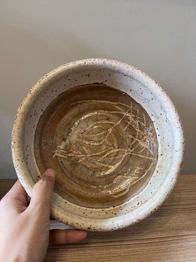Japanese handcrafted studio ceramic serving bowl / shallow dish (Category: Other Kitchenware & Tableware) located in Quezon City. Submitted by metamerchant (Listing ID 1451914382, Image 1). Description: Glaze & Finish: Features a thick, textured, and pitted white crawling/crackle glaze (yuzuhada or citron skin effect) around the exterior rim and sides, showing iron specks. Interior Detail: The inner base exposes the bare, wheel-thrown brown stone