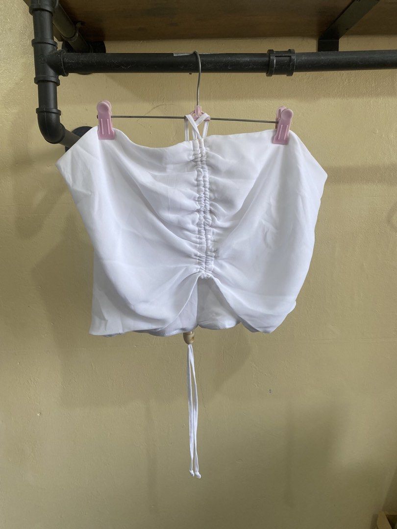 KOOKAI White Ruched Halter Neck Top (Category: Sleeveless) located in Makati City. Submitted by slickthingsph (Listing ID 1452026175, Image 1). Description: - White halter neck top from KOOKAI - Features a ruched front with drawstring detail - Ties at the back for an adjustable fit - Made from delicate 100% polyester fabric - Slight discolouration on inner strap area (please check photos for details).