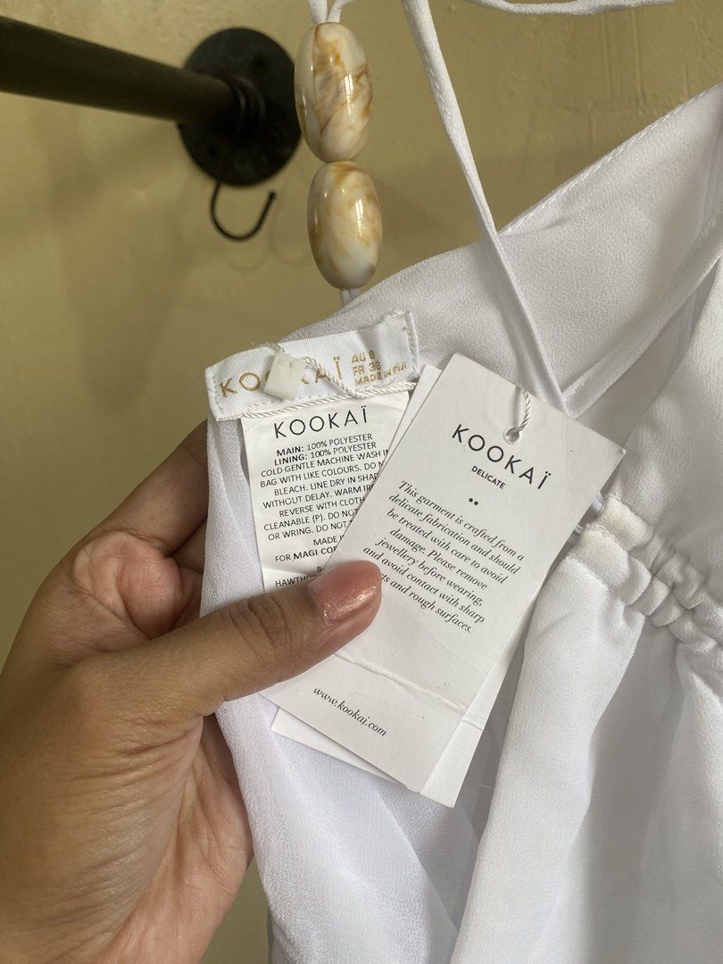 KOOKAI White Ruched Halter Neck Top (Category: Sleeveless) located in Makati City. Submitted by slickthingsph (Listing ID 1452026175, Image 3). Description: - White halter neck top from KOOKAI - Features a ruched front with drawstring detail - Ties at the back for an adjustable fit - Made from delicate 100% polyester fabric - Slight discolouration on inner strap area (please check photos for details).