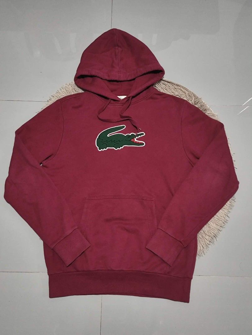 Lacoste Big Logo Hoodie (Category: Hoodies) located in Manila. Submitted by shellys_collection (Listing ID 1452052740, Image 1). Description: - Red Lacoste hoodie - Iconic green crocodile logo on front - Features a front pocket - Adjustable drawstrings for hood (slightly frayed ends) - Ideal for casual wear Dimes: 23W x 30L.