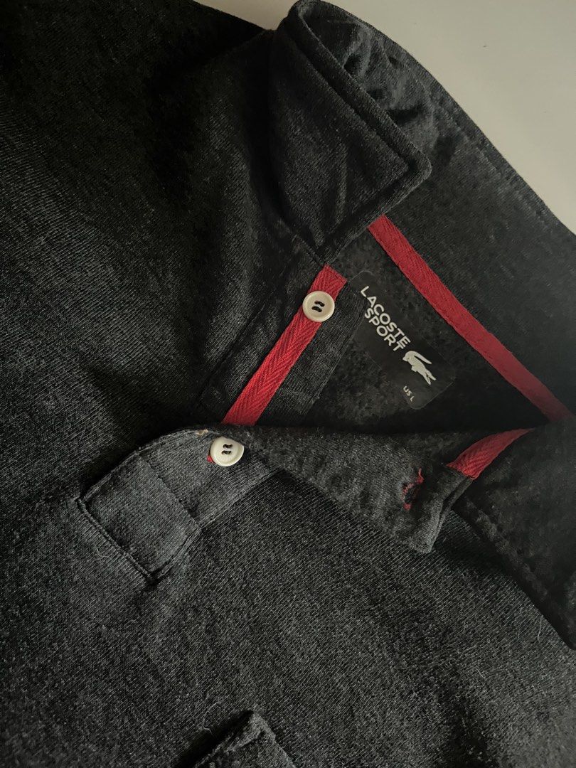 Lacoste Quarter Button (Category: Luxury Apparel) located in Santa Ana. Submitted by rlave (Listing ID 1452002531, Image 3). Description: Preloved Lacoste Sport charcoal grey long-sleeve polo, size LL. Features the signature crocodile logo embroidered on the chest pocket, button placket with red trim detailing, and a comfortable relaxed fit — great for casual or smart-casual wear. Item is in good preloved condition (see photos for actual item, in