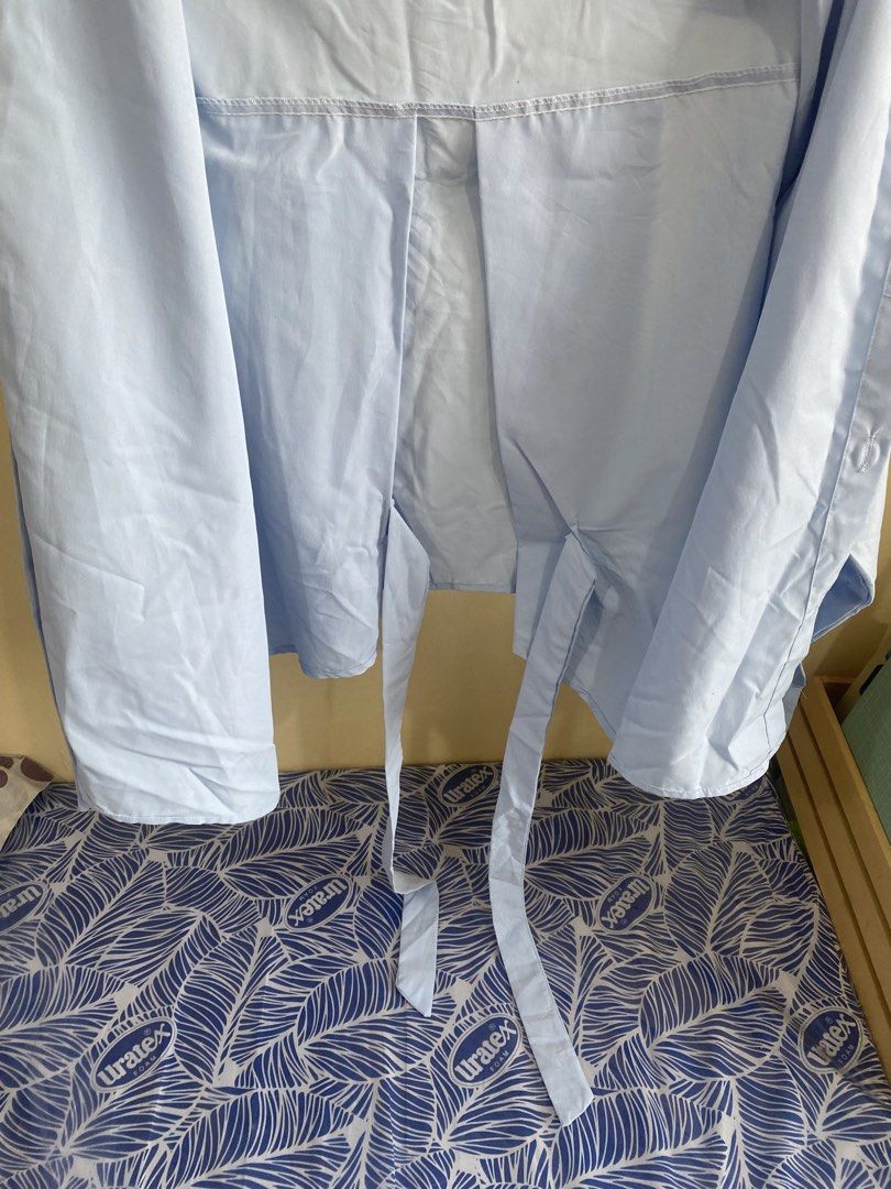 Light Blue Long Sleeve Button Up Shirt with Tie Back (Category: Longsleeves) located in Makati City. Submitted by slickthingsph (Listing ID 1452025676, Image 3). Description: - Light blue long sleeve shirt - Button-up front - Tie detail at the back - Relaxed fit - Versatile for casual wear or layering - Easy to style.