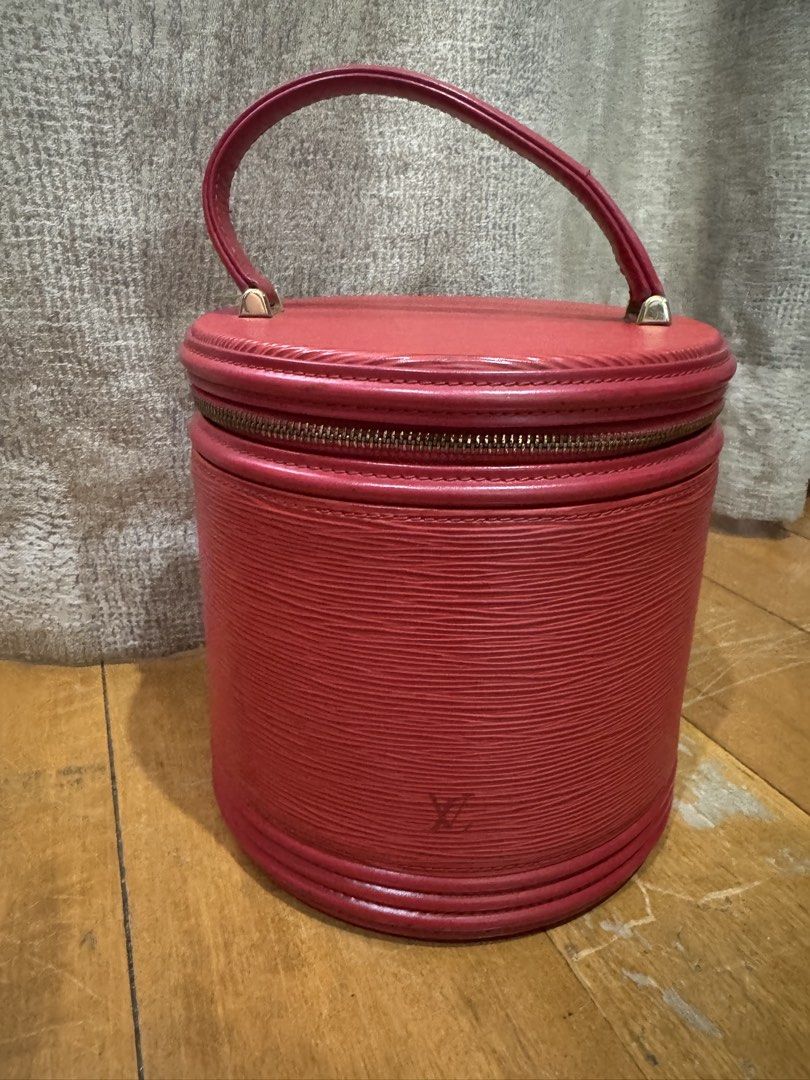 Louis Vuitton Epi Leather Vanity Case (Category: Luxury Bags & Wallets) located in Las Pinas. Submitted by katfg (Listing ID 1451942351, Image 1). Description: - Vintage Louis Vuitton vanity case - Red Epi leather - Cylindrical shape - Zip-around closure - Handle shows cracking - Small tear on leather zipper pull - Minor signs of wear on leather - Classic collectible piece.