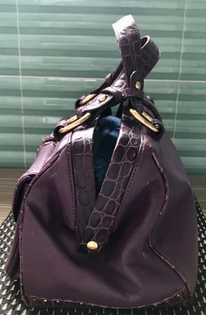 Lovcat Purple Croc Embossed Leather Handbag (Category: Luxury Bags & Wallets) located in Caloocan City. Submitted by silentfire.30c1e3 (Listing ID 1451988983, Image 3). Description: - Stylish purple handbag with luxurious heart-embossed texture. - Elegant gold-tone hardware. - Secure double metal overlapping closure. - Convenient interior zip pocket. - Fun patterned lining. - Versatile for everyday wear or evening events..