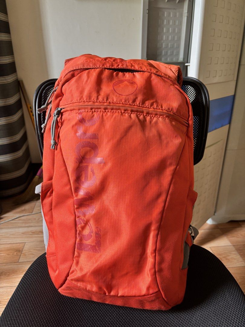 Lowepro Orange Camera Backpack (Category: Backpacks) located in Caloocan City. Submitted by juanmig_bundok (Listing ID 1451949106, Image 1). Description: - Orange Lowepro backpack, perfect for photographers on the go. - Features padded compartments inside to safely store camera gear. - Convenient top opening with an additional zippered pocket. - Includes a front zippered pocket for quick access items. - Side mesh pocket for water bottles or acces