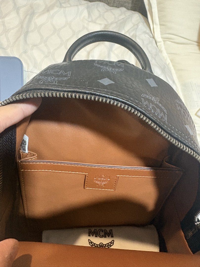 MCM Monogram Mini Backpack Black (Category: Backpacks) located in Mandaluyong City. Submitted by olxph_821033014 (Listing ID 1451952436, Image 2). Description: - Authentic MCM mini backpack - Classic black with all-over MCM monogram print - Genuine leather trim and straps - Main compartment with leather internal organization pockets - Includes a matching small MCM wallet add additional 1k - Dust bag for protection and storage - no issues like new