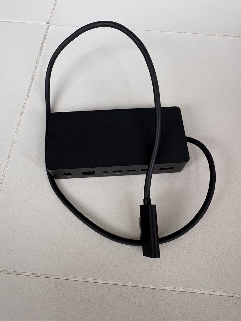 Microsoft Surface Docking Station (Category: Cables & Adaptors) located in Singapore. Submitted by maxime.redhill (Listing ID 1451979010, Image 2). Description: - Microsoft Surface Dock - Connects Surface devices to external displays, power, and accessories - Features Ethernet port - Includes USB ports - Supports display outputs - In good working condition - Selling because it's no longer needed.