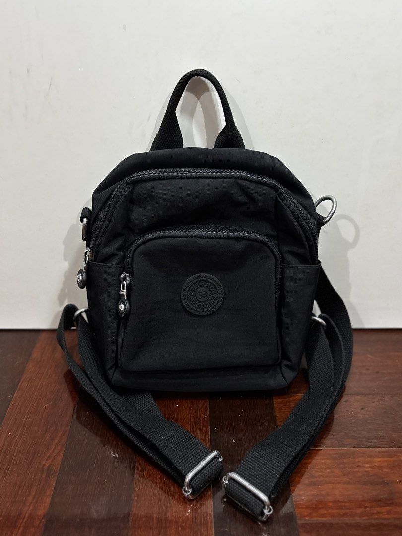 MINI BLACK BACKPACK (Category: Shoulder Bags) located in Shah Alam. Submitted by jr.staphie (Listing ID 1452029618, Image 1). Description: LETTING GO MY SUMMER COLLECTION ☀️ Description : - Preloved sling bag to let go - Colour : black - Material : Nylon - Waterproof - Dimensions : 24cm (H) x 11cm (W) x 21cm (L) - Got it for RM 54 previously, letting go at 50% - Used it 2x for outdoor walking + cafe hopping + photoshoot Delivery : ✅ Located in Sa