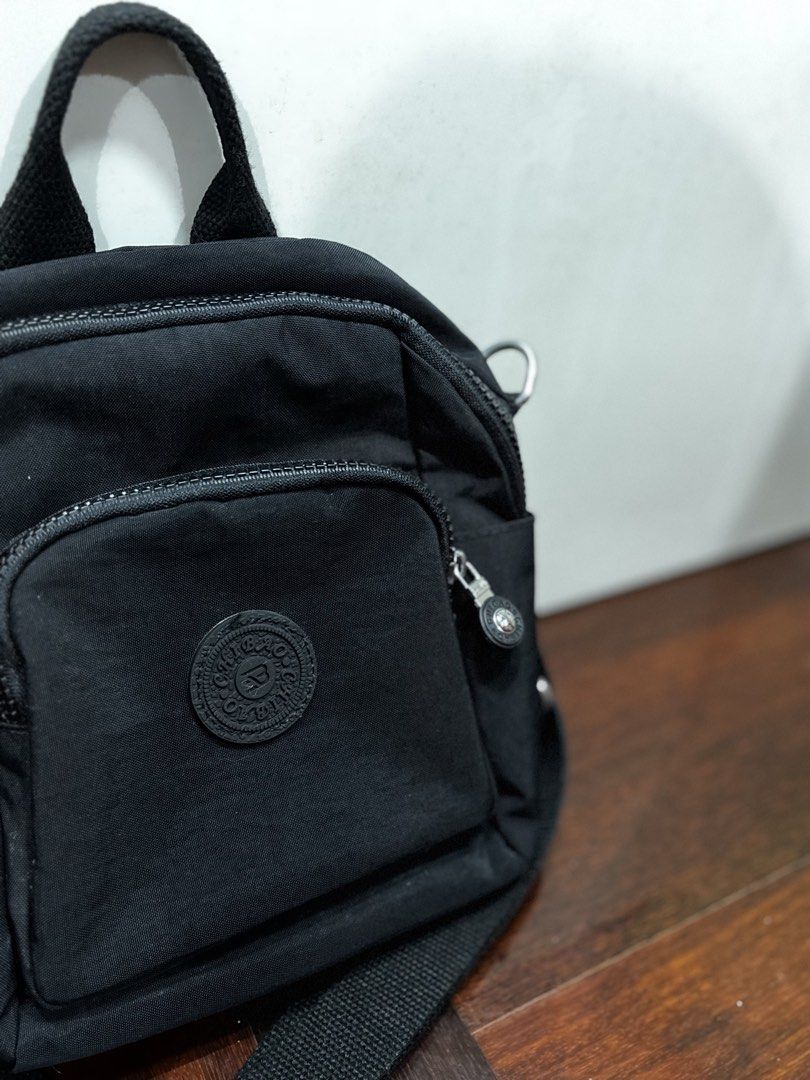 MINI BLACK BACKPACK (Category: Shoulder Bags) located in Shah Alam. Submitted by jr.staphie (Listing ID 1452029618, Image 3). Description: LETTING GO MY SUMMER COLLECTION ☀️ Description : - Preloved sling bag to let go - Colour : black - Material : Nylon - Waterproof - Dimensions : 24cm (H) x 11cm (W) x 21cm (L) - Got it for RM 54 previously, letting go at 50% - Used it 2x for outdoor walking + cafe hopping + photoshoot Delivery : ✅ Located in Sa