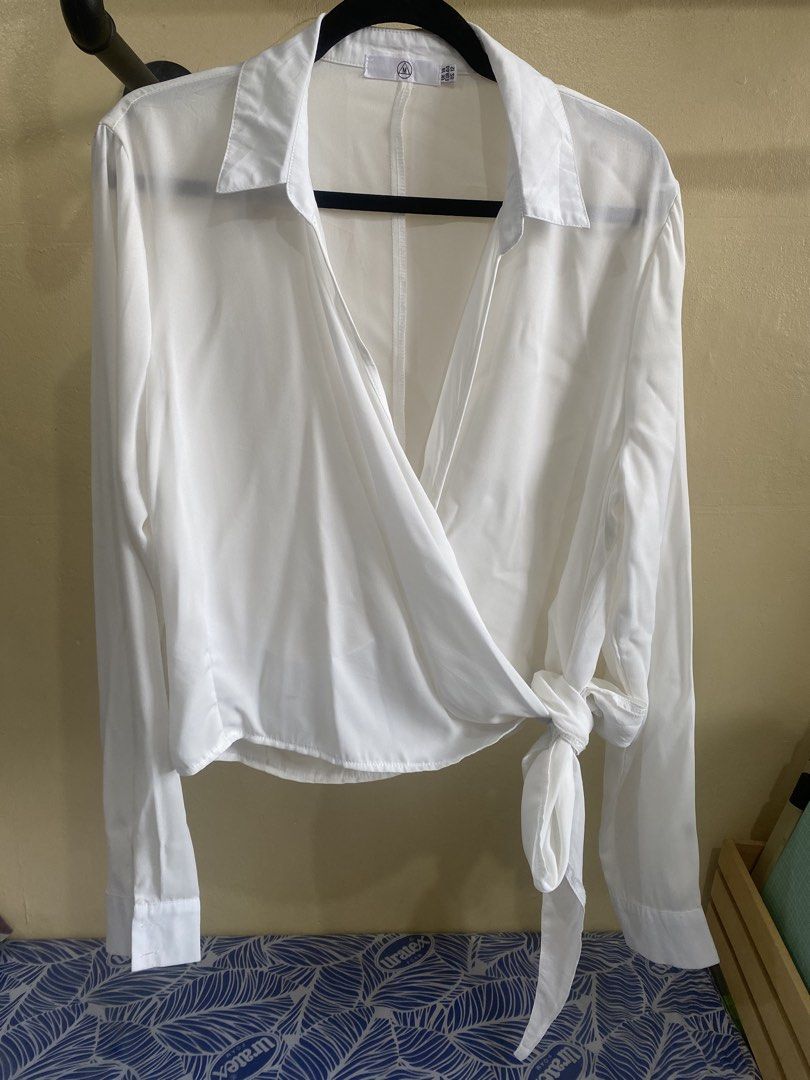 Missguided White Wrap Long Sleeve Shirt Top (Category: Blouses) located in Makati City. Submitted by slickthingsph (Listing ID 1452027913, Image 1). Description: - White wrap shirt from Missguided - Long sleeves with button cuffs - Adjustable tie detail at the side - Sheer material for a delicate look - Minor faint stain on the collar (visible in the last photo) - Otherwise in good pre-loved condition.