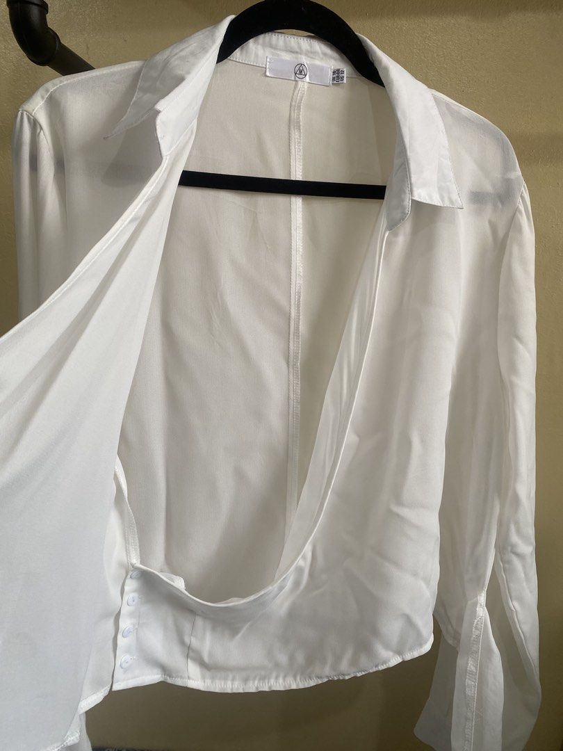Missguided White Wrap Long Sleeve Shirt Top (Category: Blouses) located in Makati City. Submitted by slickthingsph (Listing ID 1452027913, Image 3). Description: - White wrap shirt from Missguided - Long sleeves with button cuffs - Adjustable tie detail at the side - Sheer material for a delicate look - Minor faint stain on the collar (visible in the last photo) - Otherwise in good pre-loved condition.