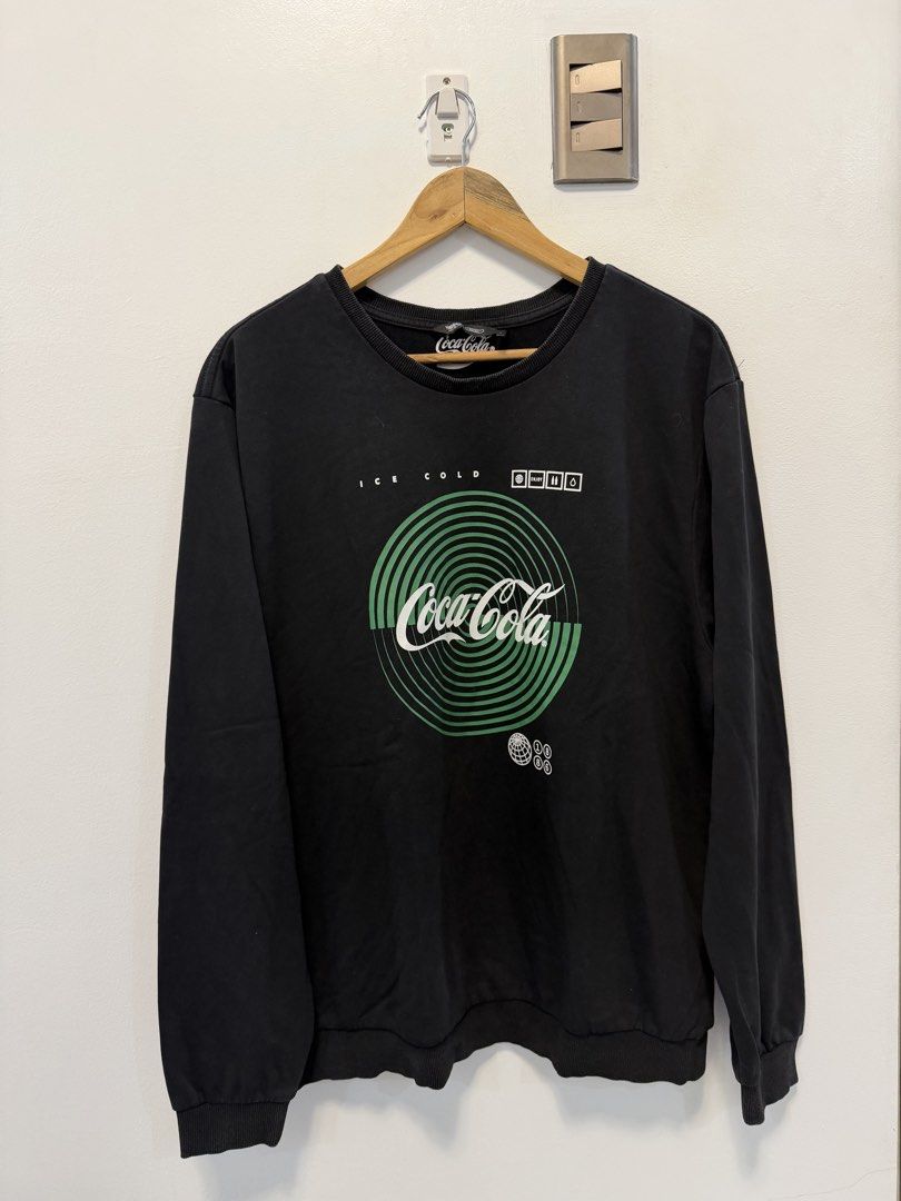 Mossimo x Coca-Cola "Ice Cold" Graphic Black Long Sleeve Sweatshirt (Category: Coats, Jackets and Outerwear) located in Taguig. Submitted by chrisern35 (Listing ID 1452003313, Image 1). Description: Official Mossimo x Coca-Cola long sleeve pullover sweatshirt in solid black. Features a green “Ice Cold” spiral Coca-Cola graphic on the front and a embroidered/printed Mossimo logo on the upper back neck. Perfect for casual streetwear layering or coz