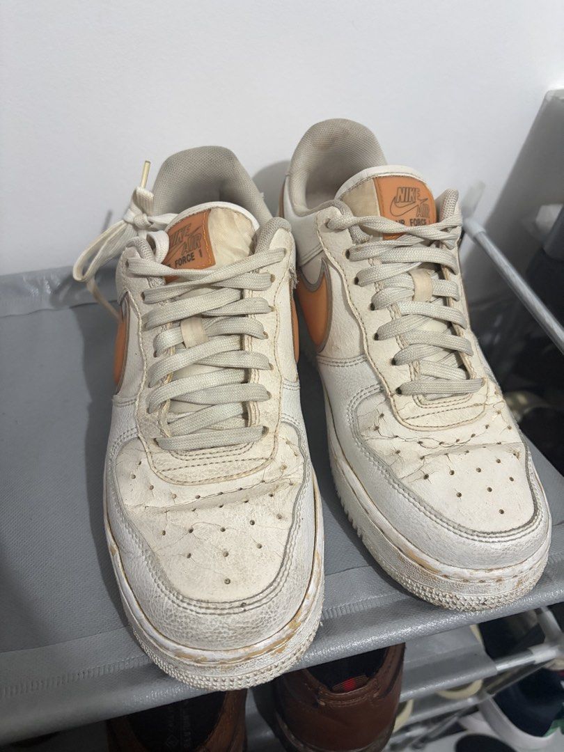 Nike Air Force 1 White Orange Sneakers (Category: Sneakers) located in Santa Rosa. Submitted by mm024 (Listing ID 1451946816, Image 1). Description: - White and orange Nike Air Force 1s - Visible wear and tear on leather, particularly toe boxes - Soles are dirty - Shoes have been worn but still have plenty of life left.