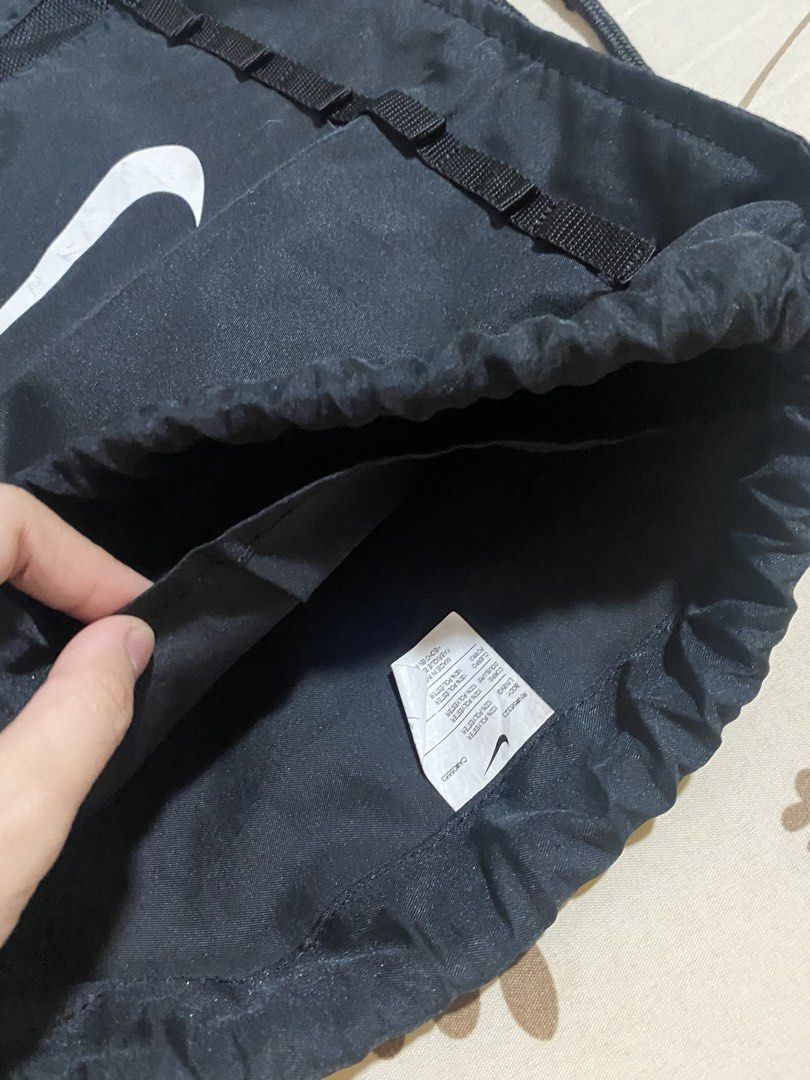 Nike Black Drawstring Bag (Category: Backpacks) located in Manila. Submitted by mpt99876 (Listing ID 1452067625, Image 3). Description: - Classic black Nike drawstring bag - Features the iconic Nike swoosh logo - Adjustable shoulder straps double as drawstring closure - Small Nike tag detail on the side - Perfect for gym sessions or everyday errands - Ample space for your essentials.