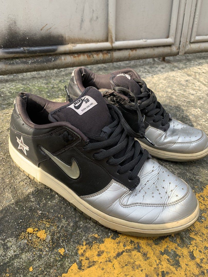 Nike SB Dunk Low Pro Supreme Black Silver (Category: Sneakers) located in Manila. Submitted by aris_bantug_complex (Listing ID 1451955715, Image 2). Description: - Supreme x Nike SB Dunk Low Pro - Colorway: Black and Silver - Iconic Supreme star logo on the side - Laces feature 'Famous World' text - Classic skate shoe design .